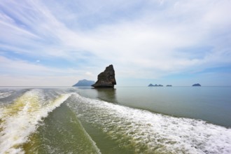 Boat trip in the Gulf of Thailand. The picturesque island-rock float in a sea mist