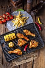 Rustic Grilled chicken wings, legs, and spicy corn