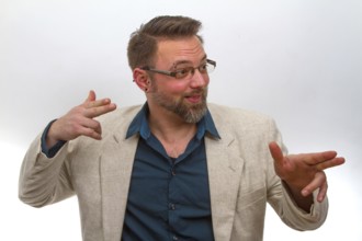 Young man points with finger on light background