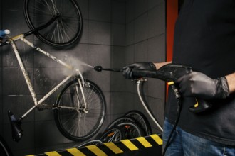 Services professional washing of bicycle in the workshop. Close-up of hand Young Caucasian stylish