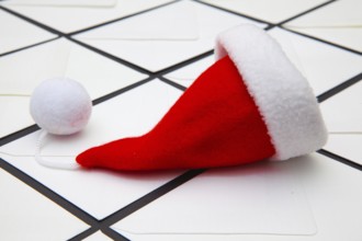 Santa Claus red hat and Christmas white envelopes. Christmas composition