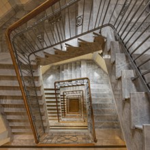 View from above of a spiral marble staircase with a striking banister and geometric pattern, Old