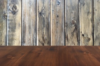 Old brown oak wooden table on the blurry wood wall background, wood table