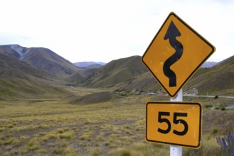 Traffic sign in New Zealand indicating a road with bends