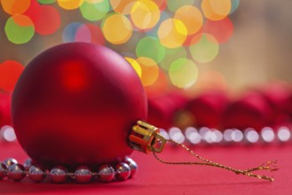 Big red christmas ball on red background horizontal version