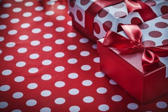 Christmas gifts on polka-dot red textile celebrations concept