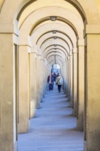 Vasari Corridor with tourists in Florence, Italy