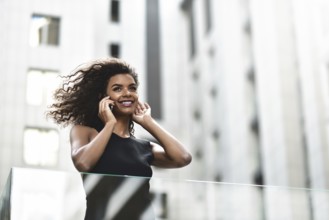 Happy smiling afroamerican woman have a nice conversation at street