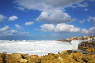 Storm on the Mediterranean Sea. Huge waves with white foam collapse at the Old Port of Jaffa in Tel