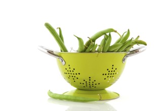Green colander and French beans to wash and prepare