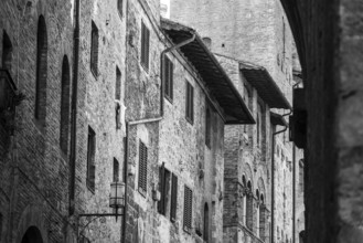 Facade of typical medieval residential houses in downtown San Gimignano, Italy