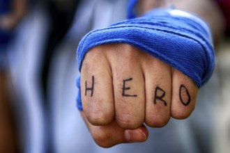 Angry mans fist punching with hero letter on the fingers water. Human power force