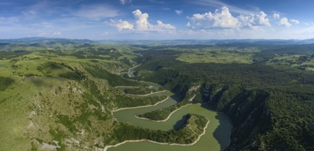 Aerial panorama of meanders at rocky river Uvac gorge on sunny day, southwest Serbia