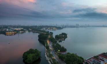 The skyline of Hanoi, the capital city of Vietnam and the Hoan Kiem lake during a colorful sunset