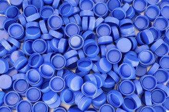Blue plastic bottle caps. Studio shot. Plastic waste