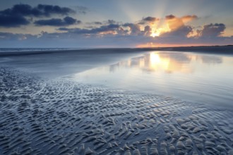 Sunrise over North sea coast at low tide, Holland