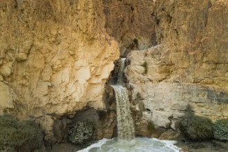 Unexpected powerful waterfall in the Judean Desert around the Dead Sea after heavy winter rains.