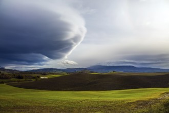 The thunderstorm begins. Picturesque hills of the legendary Tuscany. Beautiful Italy. Flat rows of