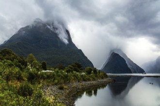 Magic country of fantastic heroes. New Zealand. Storm clouds cover the sky over the famous ocean