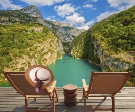 Travel across Provence. Two wooden chaise lounges on platform at the lake Verdon