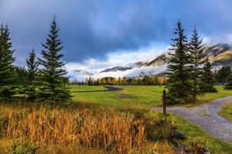 Canada, Banff. Rocky mountains in the clouds. Sports field in the vicinity of the city. Cool and