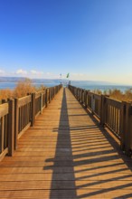 Wooden pier leading to the famous Sea of Galilee. Sunset on the lake of Kinneret