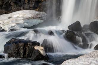 Water from waterfall splashing on a rocky river. The Oxararfoss waterfall in pingvellir Thingvellir
