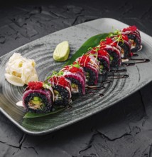 Food, Vibrant sushi rolls are arranged beautifully on a dark plate, showcasing various colors and