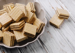 Food, Crisp layered wafers are neatly arranged in a bowl, their patterns creating an inviting look.