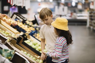 Kinder kleines süßes Mädchen und Teenager Junge Einkaufen für frisches Bio-Obst und Gemüse im