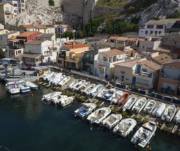 The famous harbour and port Vallon des Auffes situated between historic buildings offers an unique