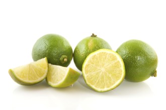 Fresh green limes cut isolated over white