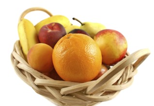 Cane basket filled with freshly picked colorful organic fruit