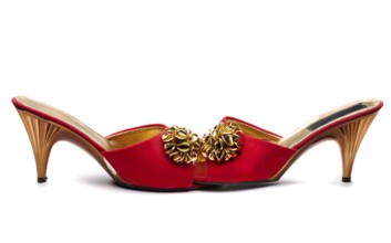 Pair red female shoe with gold brooch. Isolate on white