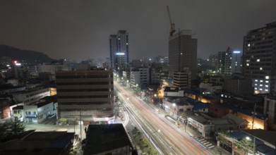 Metropolis at night. Cityscape with cars driving on highway. Seoul, Republic of Korea