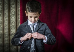 Boy in vintage black suit and tie