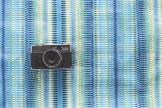 Vintage photocamera on blue paper background