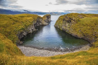The picturesque coastal bay near the fishing village of Arnastapi. Iceland in July