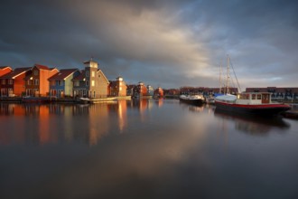 Boats, ships and colorful buildings duirng sunrise at Reitdiephaven, Groningen, Netherlands