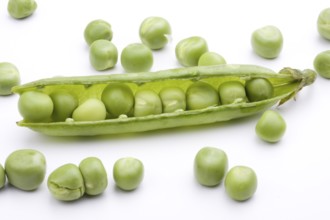 Fresh green peas on a white background