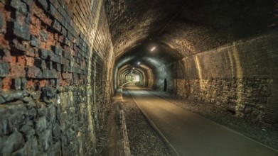 Walking through the Headstone Tunnel, near Monsal Head in the East Midlands, Derbyshire, Peak