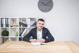 Portrait of a Caucasian male indoors posing in a jacket and white shirt. Overweight office worker