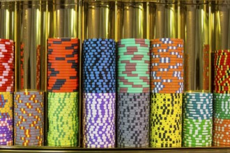 Colourful roulette chips in a casino on a gambling table. Lots of chips with different nomination