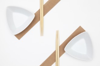 Top View Of White Empty Sushi Plates With Bamboo Chopsticks. Symmetry Food Design