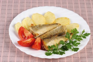 Fried fish and potato dinner on the table