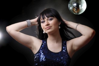 Girl in the nightclub is dancing in lights