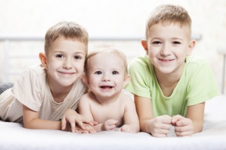 Family happiness, three little smiling child boy brothers