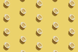Conceptual pattern with halves of lemon collection with shadow on yellow background. Healthy