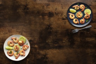 Shrimps, overhead flat lay banner with copy space. Fried shrimp with lime, two plates, shot from