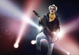 Young man rock musician in lights of stage